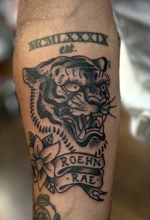 Black and gray tiger with flower banner tattooed in the American Traditional style. Made at Denver's finest Dedication Tattoo.