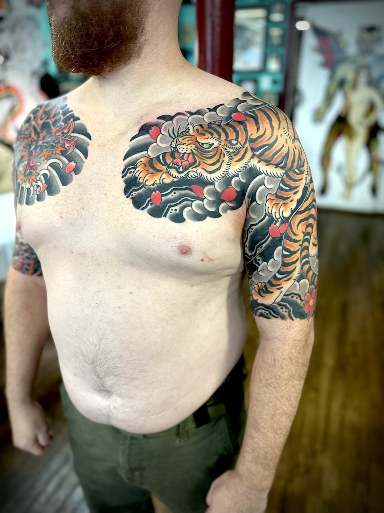Tiger and dragon half panels tattooed in the Japanese Traditional style. Made at Denver's finest Dedication Tattoo.