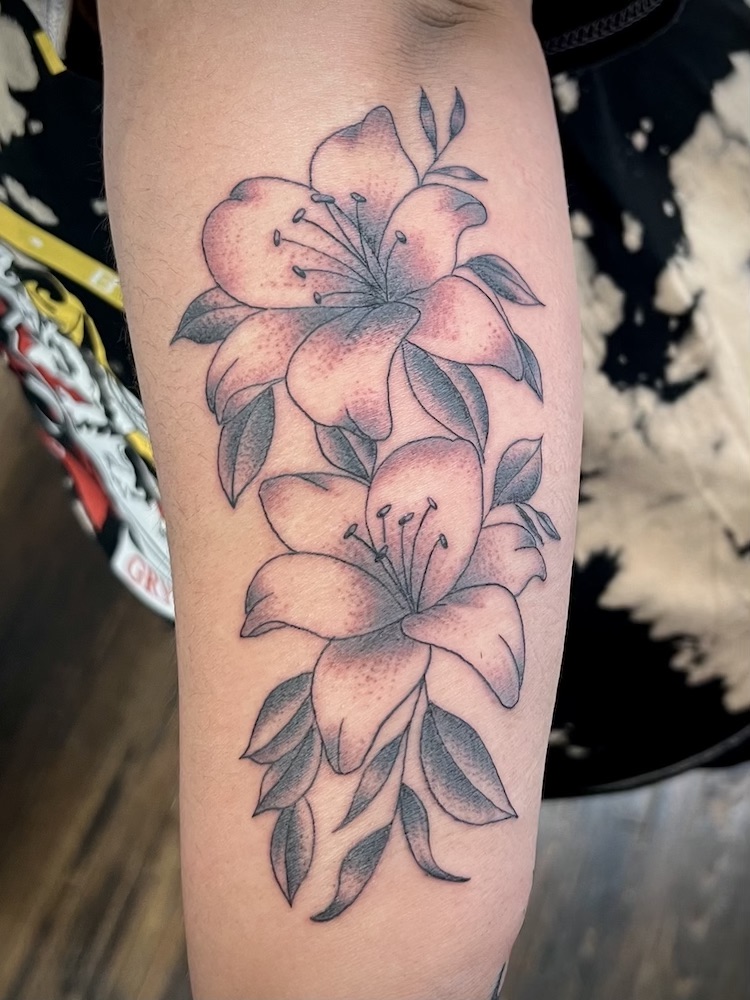 Lily Flowers tattooed in the American Traditional style. Made at Denver's finest Dedication Tattoo.
