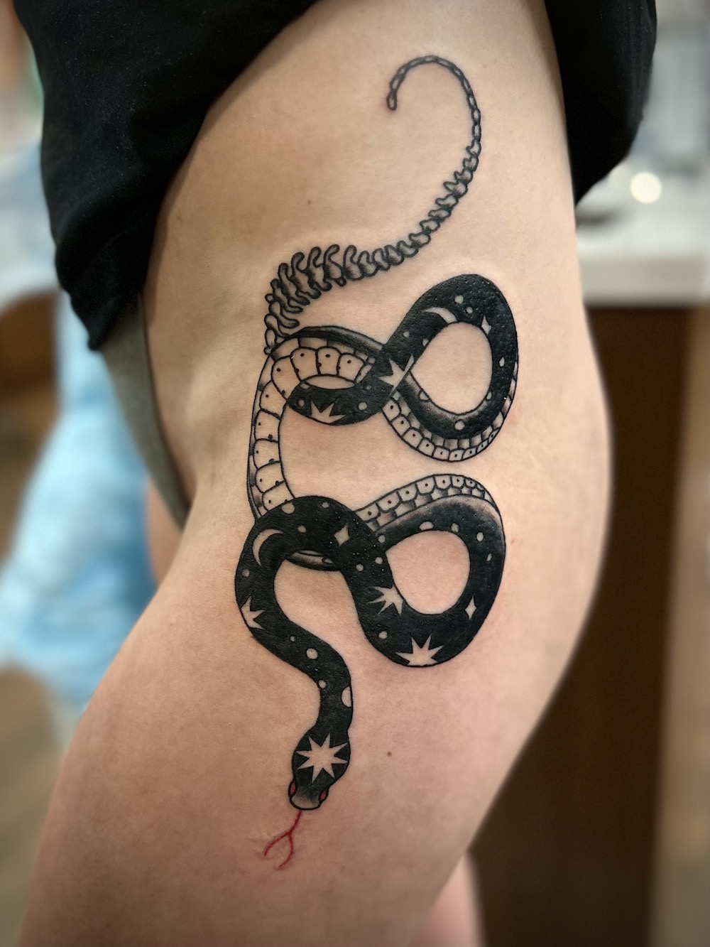 Celestial Snake tattooed in the American Traditional style. Made at Denver's finest Dedication Tattoo.