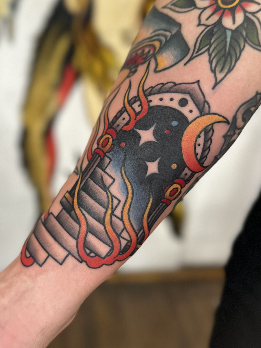 Portal on the arm tattooed in the American Traditional style. Made at Denver's finest Dedication Tattoo.